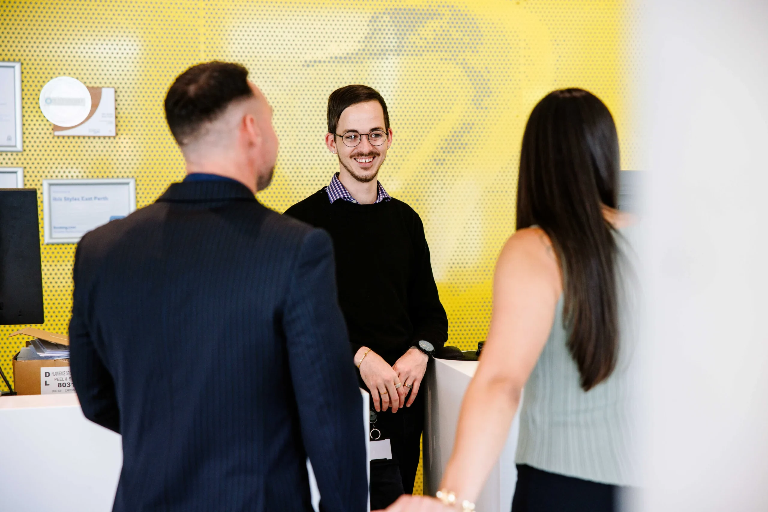 Couple checking in at ibis Styles East Perth, a comfortable budget hotel Perth offering hotel deals perth